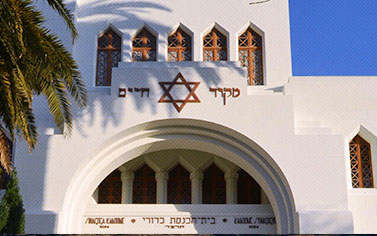 A white building with a star of david on the front.