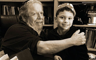 A man and boy sitting next to each other.