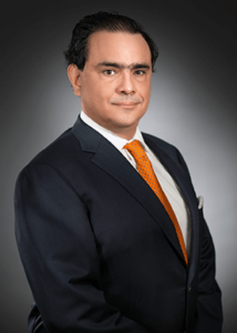 A man in a suit and tie standing up.