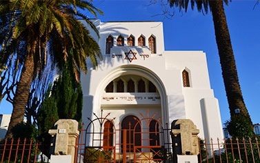 A white church with a star of david on the front.