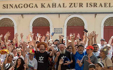 A large group of people standing in front of a building.