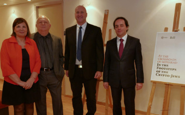 Three men in suits and ties standing next to each other.