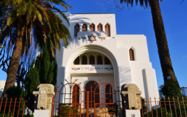 A white church with a star of david on the front.