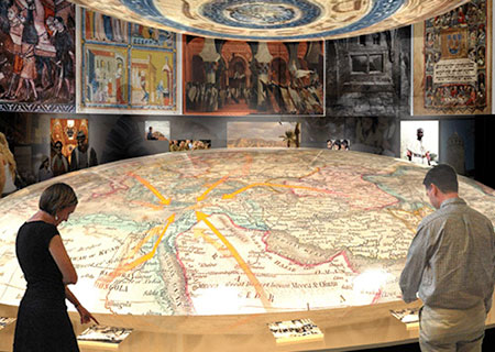 A large map of the world is shown in a room.
