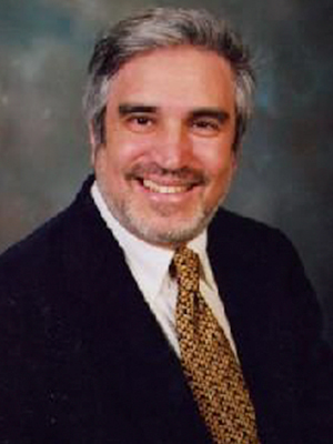 A man with a beard and suit jacket