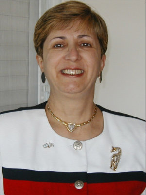 A woman with short hair wearing a white jacket.